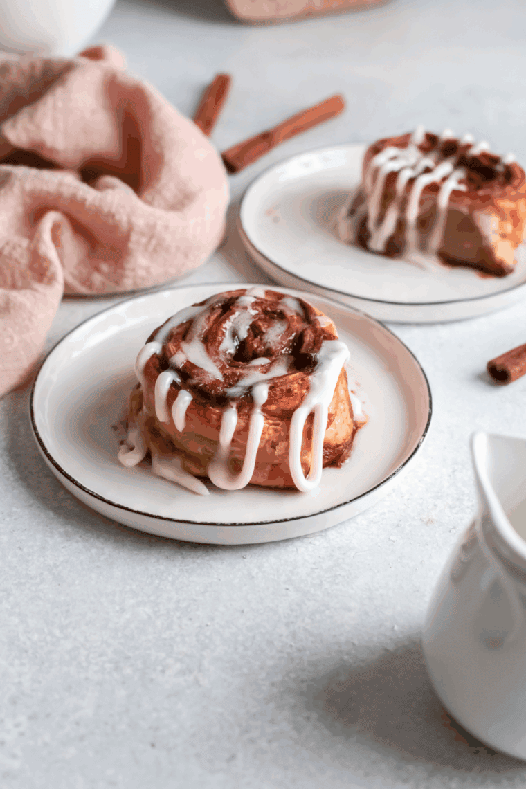 Air fryer apple cinnamon rolls topped with icing and baked until golden brown