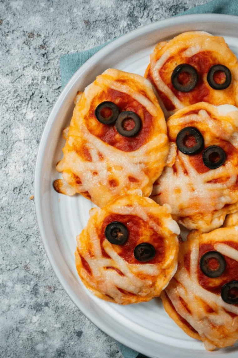 Halloween mummy pizza made in air fryer with melted cheese bandages and spooky face design