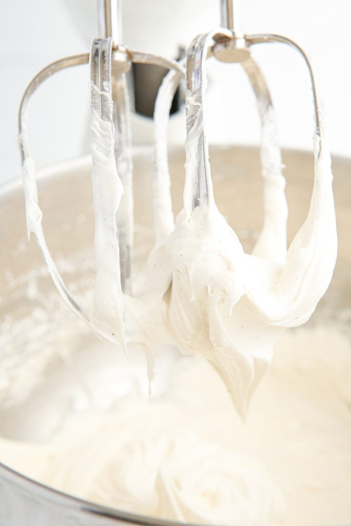 Making frosting for the cookies in a mixing bowl.