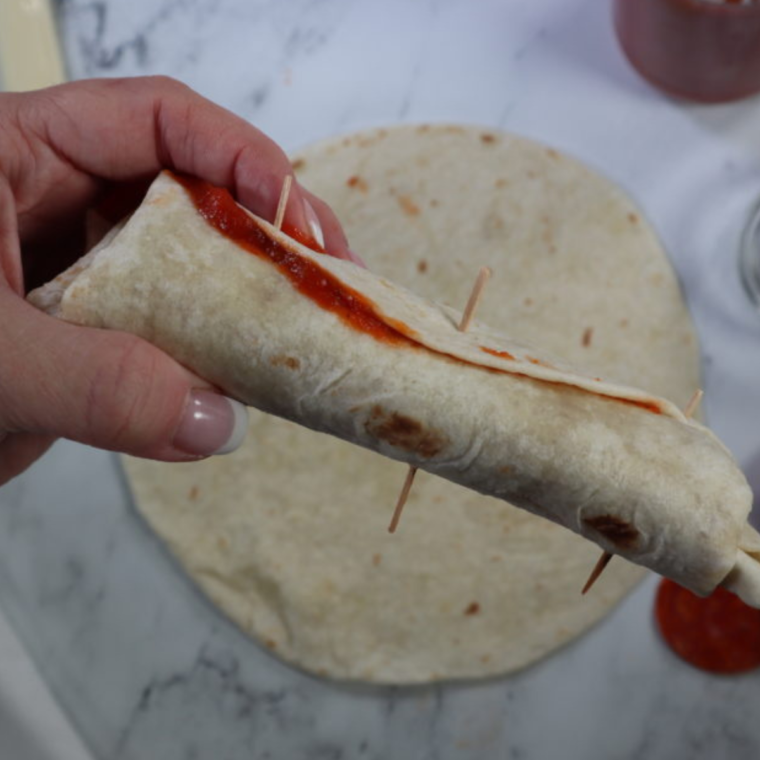 Roll up the tortilla, and then place toothpicks into them, to keep it together.