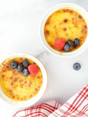 Air fryer creme brulee in a white ramekin with a cracked caramelized sugar top