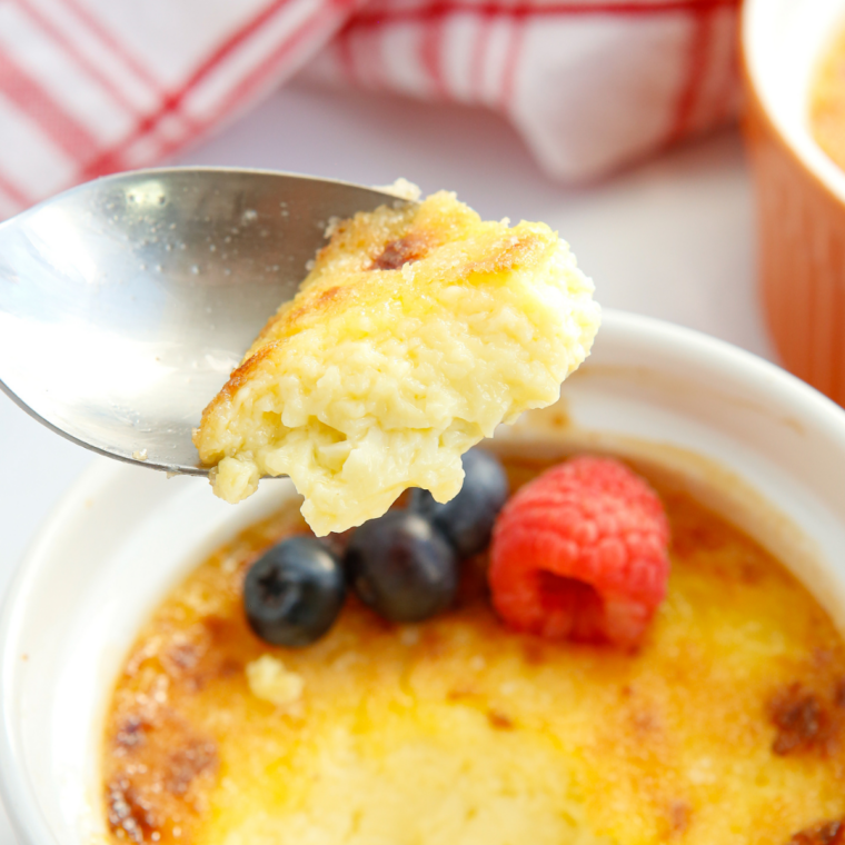 Spoonful of creamy vanilla custard lifted from a ramekin