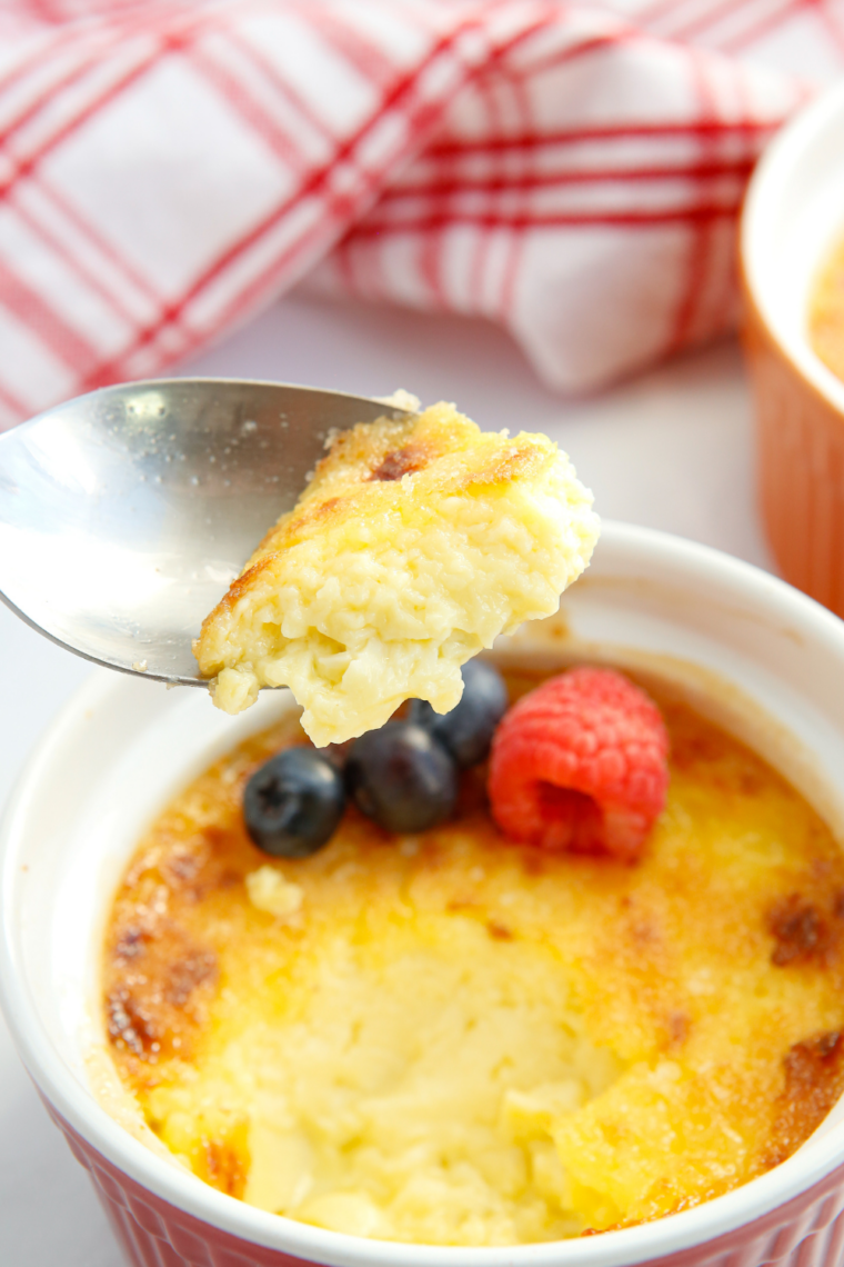 Spoon cracking through the caramelized sugar crust on air fryer creme brulee