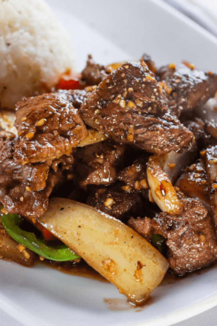 Close-up of air fryer cube steak sliced open showing tender juicy texture and browned crust.