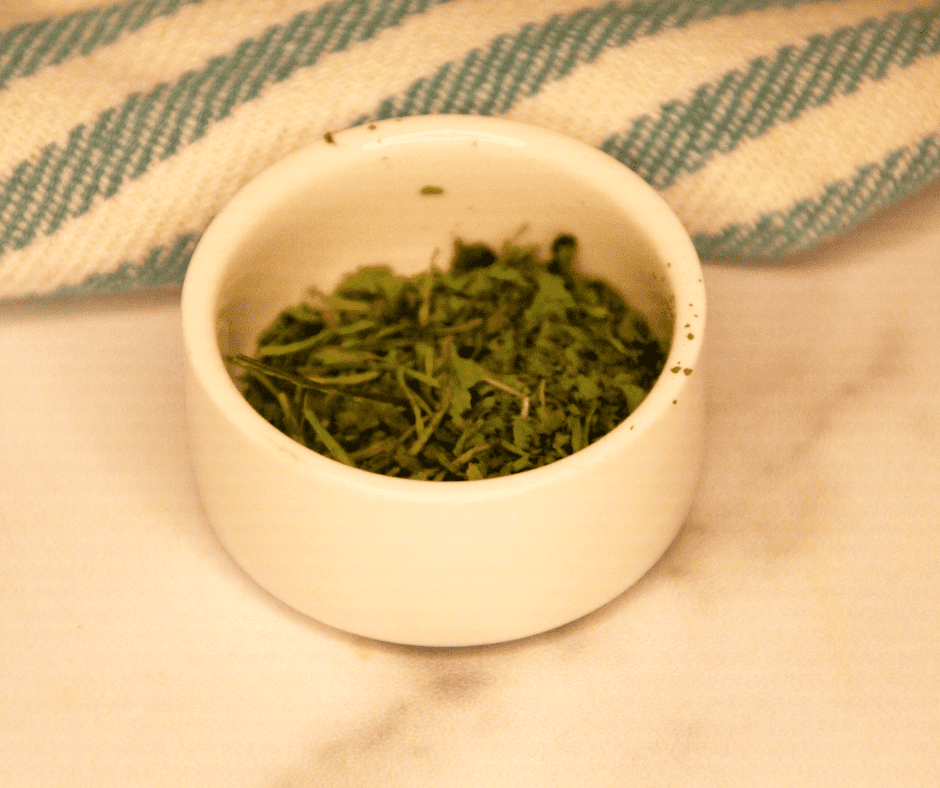 "Fresh cilantro being dehydrated in the air fryer, ready for long-term storage."