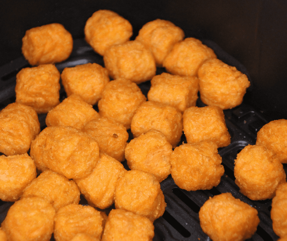 A plate of crispy Air Fryer Frozen Sweet Potato Tots served with dipping sauce.