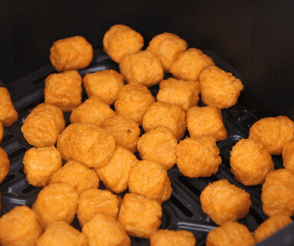 Golden and crispy Air Fryer Frozen Sweet Potato Tots in a basket, ready to enjoy.
