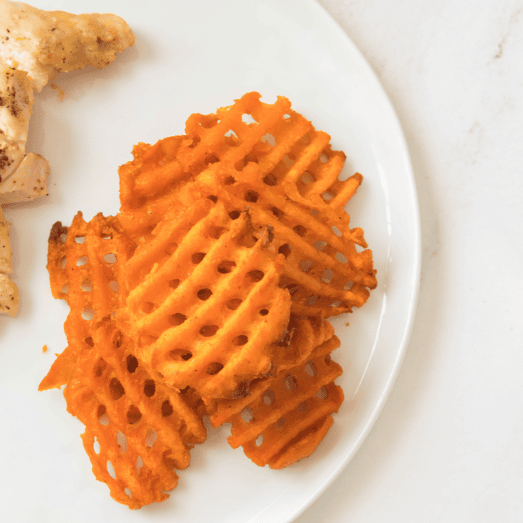 A plate of Air Fryer Frozen Sweet Potato Waffle Fries, golden and crispy.