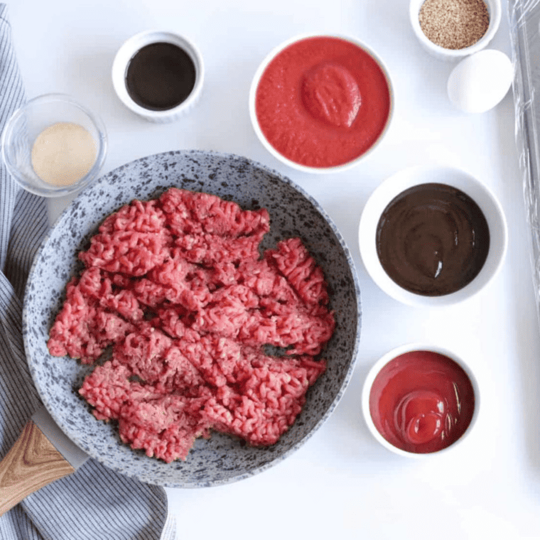 Cooking ground beef with Worcestershire sauce in a pan on medium heat, breaking it into small pieces with a spatula for Air Fryer Sloppy Joe Bites.
