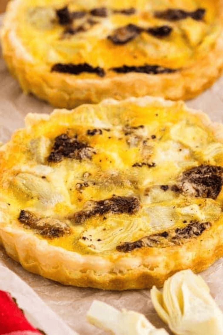 Golden, set air fryer quiche removed from the tart pan and cooling on a rack.