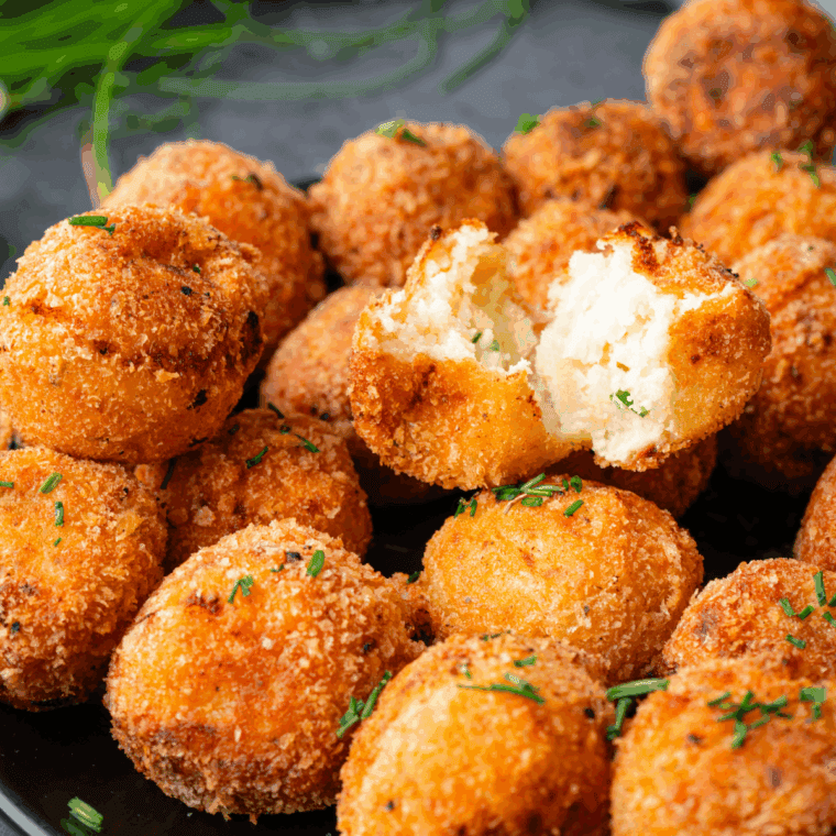 Golden, crispy loaded baked potato tots topped with melted cheese, crumbled bacon, and chopped green onions