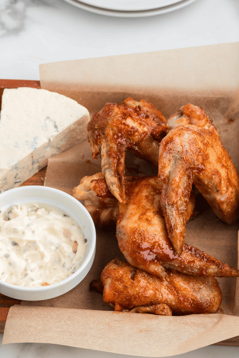 Serving crispy Hickory Smoked BBQ chicken wings on a plate.