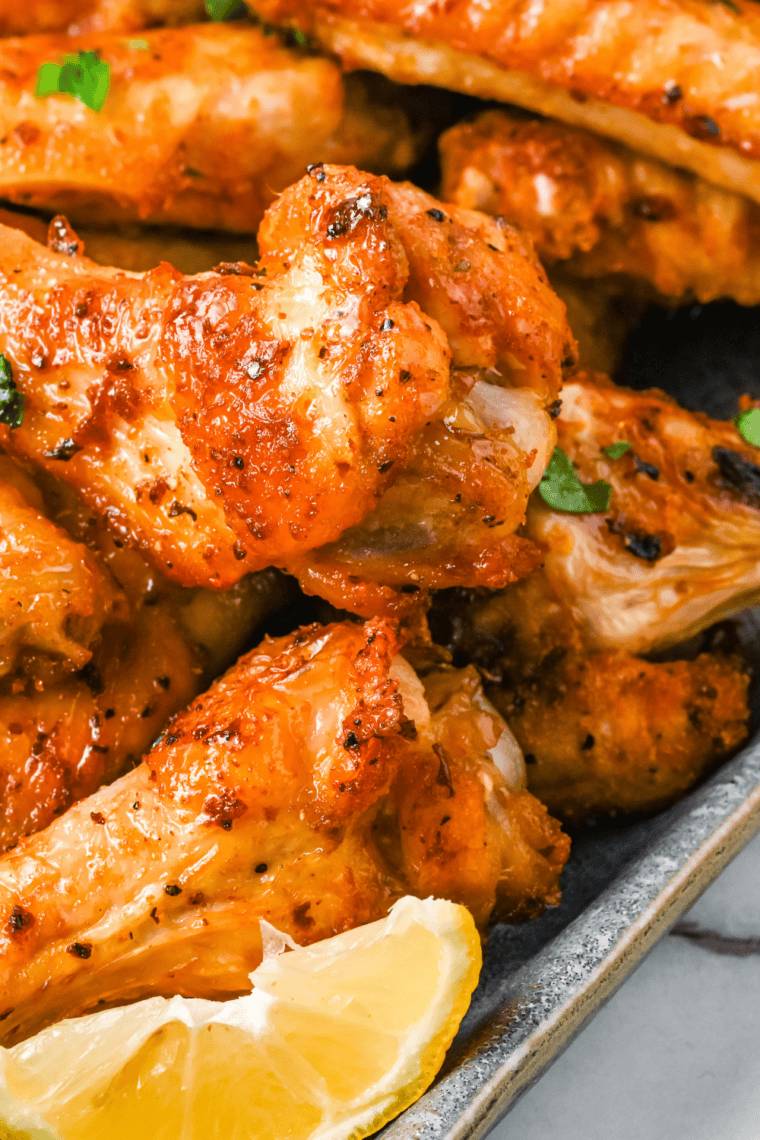 Plate of crispy Wingstop-style Hot Honey Rub chicken wings with sticky sweet and spicy glaze.