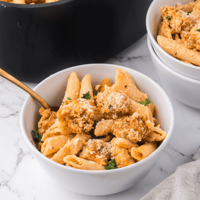 Air fryer basket filled with golden crispy Foster Farms chicken strips fresh from cooking.