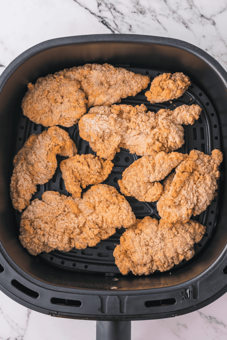 Air fryer being preheated to 390°F for cooking Foster Farms chicken strips evenly and golden brown.