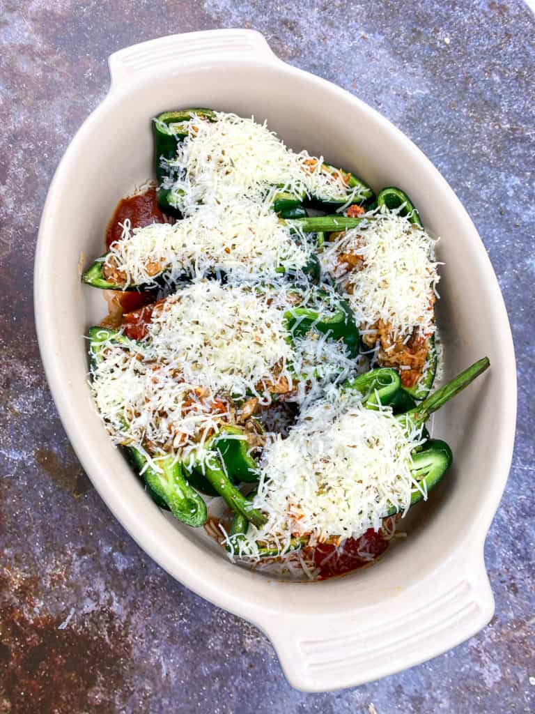 Plate of Air Fryer Stuffed Poblano Peppers filled with quinoa and turkey, garnished with cheese and herbs.