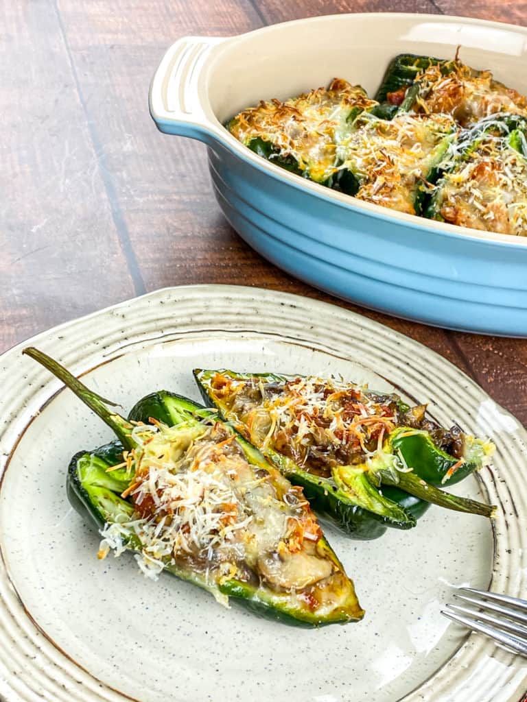 A colorful bowl of Air Fryer Stuffed Poblano Peppers filled with taco-seasoned ground beef, corn, and tomatoes, topped with melted cheese, garnished with fresh cilantro.