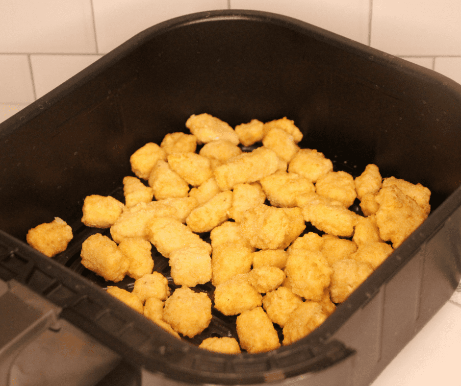 Plate frozen cheese curds into the air fryer basket.