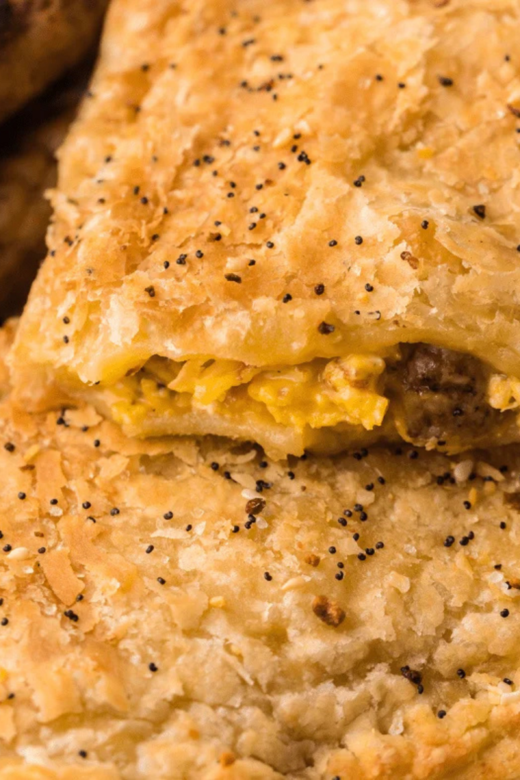 Close-up of baked egg tarts with lightly browned tops inside an air fryer basket