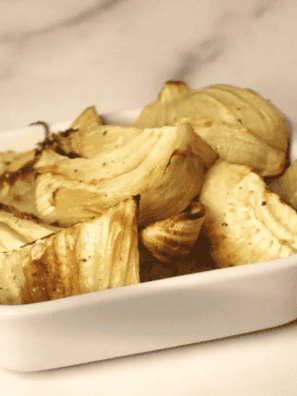 Plate of air fryer fennel wedges with caramelized golden-brown edges
