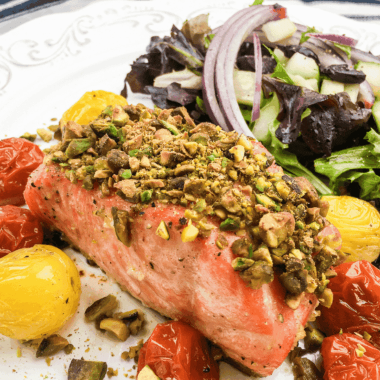 Golden pistachio-crusted salmon cooked in the air fryer, served on a plate