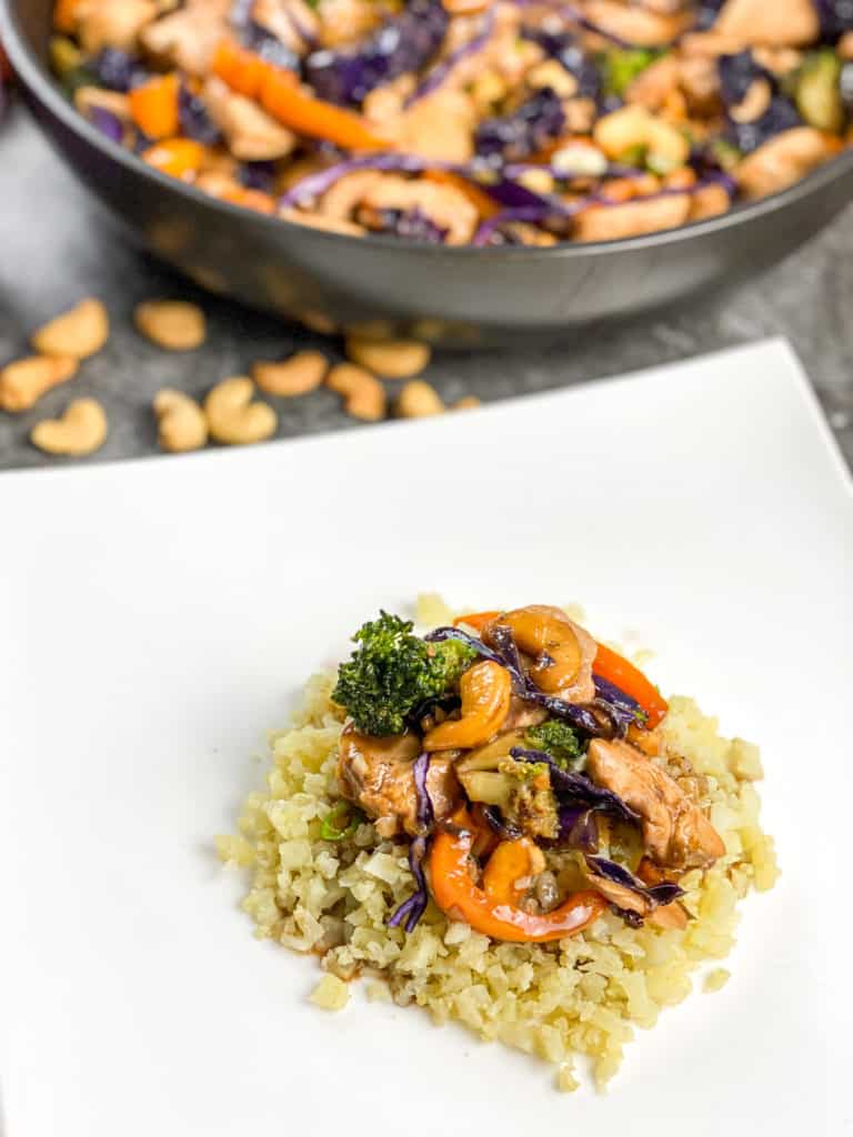 Close-up of air fryer chicken and cabbage stir-fry, highlighting the crispy chicken pieces and fresh, vibrant cabbage with a glossy glaze.