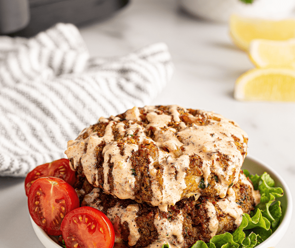 Bowl of creamy Keto Remoulade Sauce with a spoon, perfect for dipping seafood, meats, or vegetables.