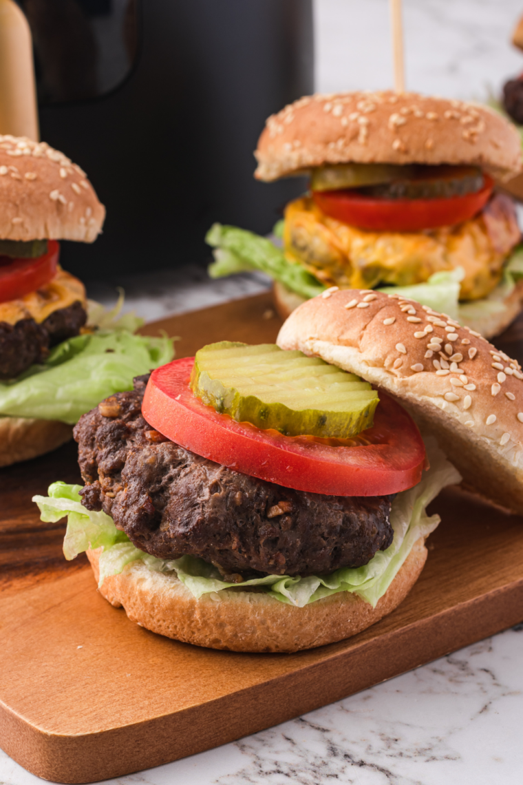 Close-up of a thick Bubba Burger in an air fryer basket while cooking