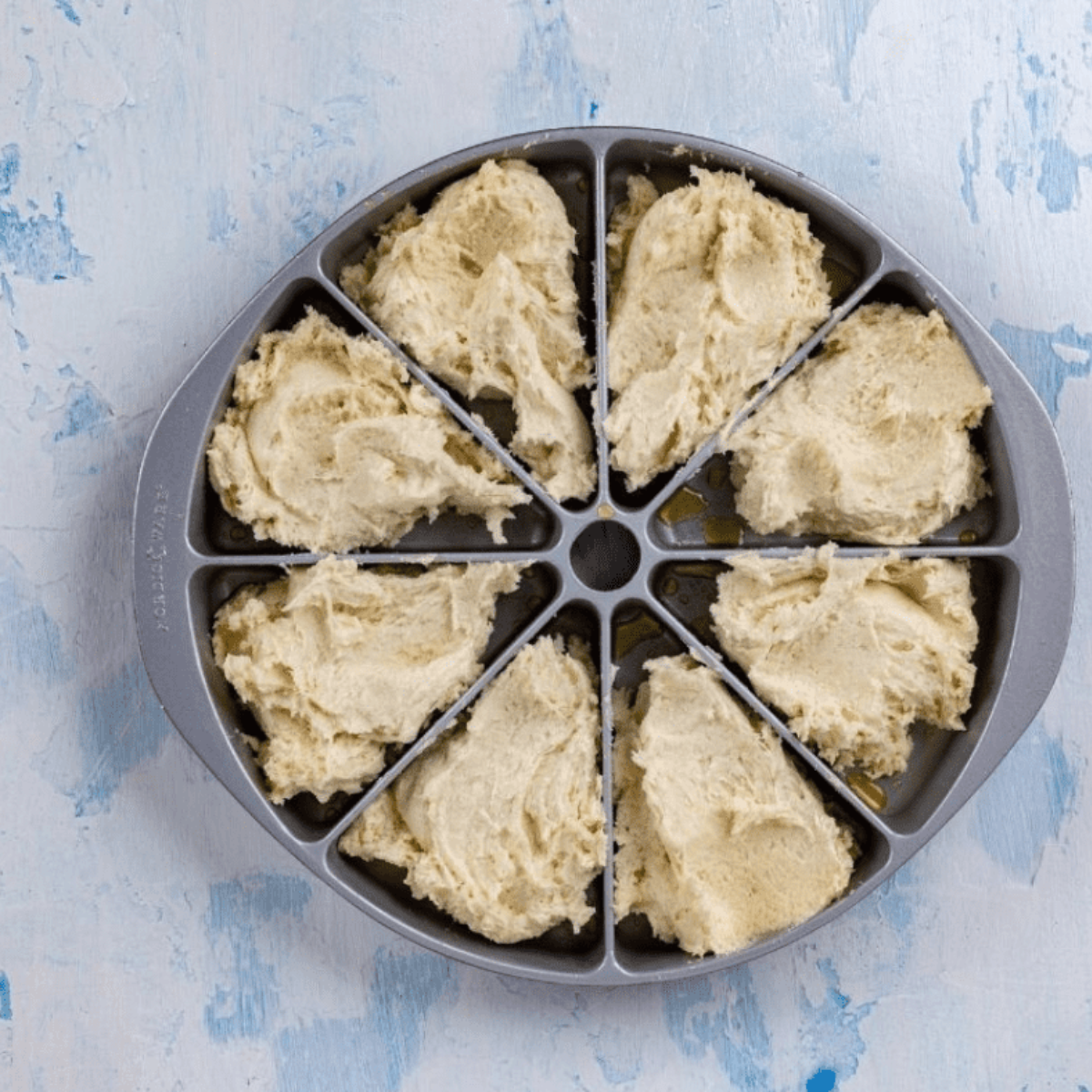 Scone dough patted into a circle and cut into eight equal triangles on a floured surface