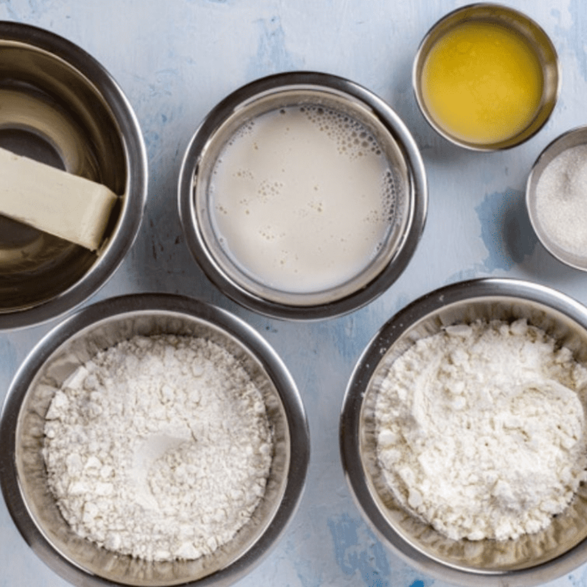 Ingredients for vanilla bean scones: flour, sugar, cold butter, heavy cream, and a vanilla bean