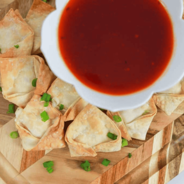 A plate of golden, crispy Air Fryer Cream Cheese Rangoon served as a delicious appetizer.