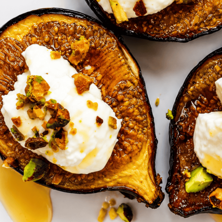 Close-up of air fryer roasted fig halves and whipped cream on a plate of golden French toast