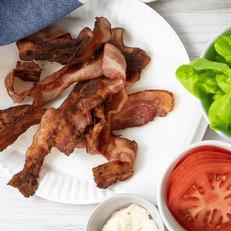 Plated crispy Blackstone griddle bacon served with pancakes for breakfast