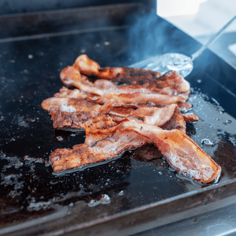 Perfectly crispy bacon cooked on a Blackstone griddle ready to serve