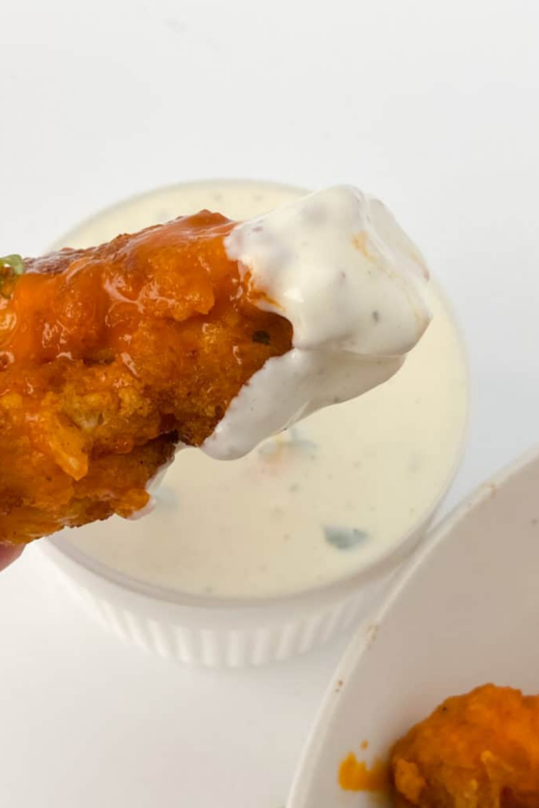 Golden, crispy chicken tenders coated in spicy buffalo sauce, served with celery sticks and a side of ranch or blue cheese dressing.