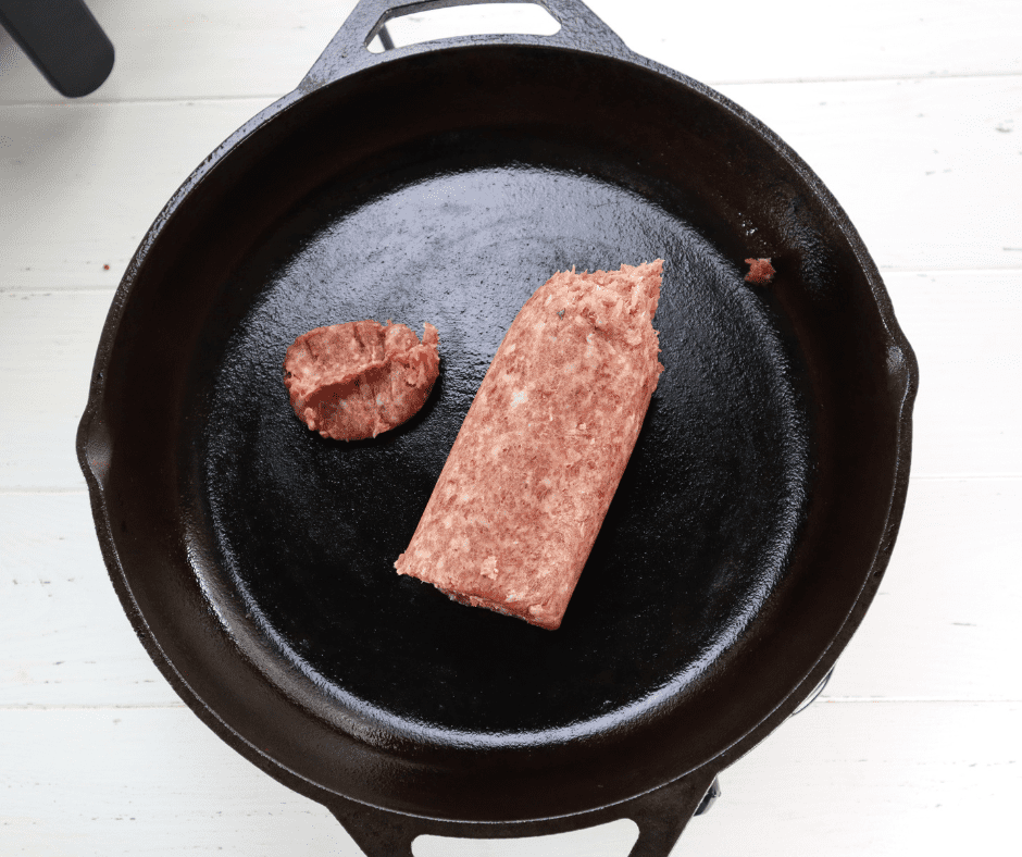 Cooking sausage in a skillet until browned for Copycat McDonald's Breakfast Burritos.