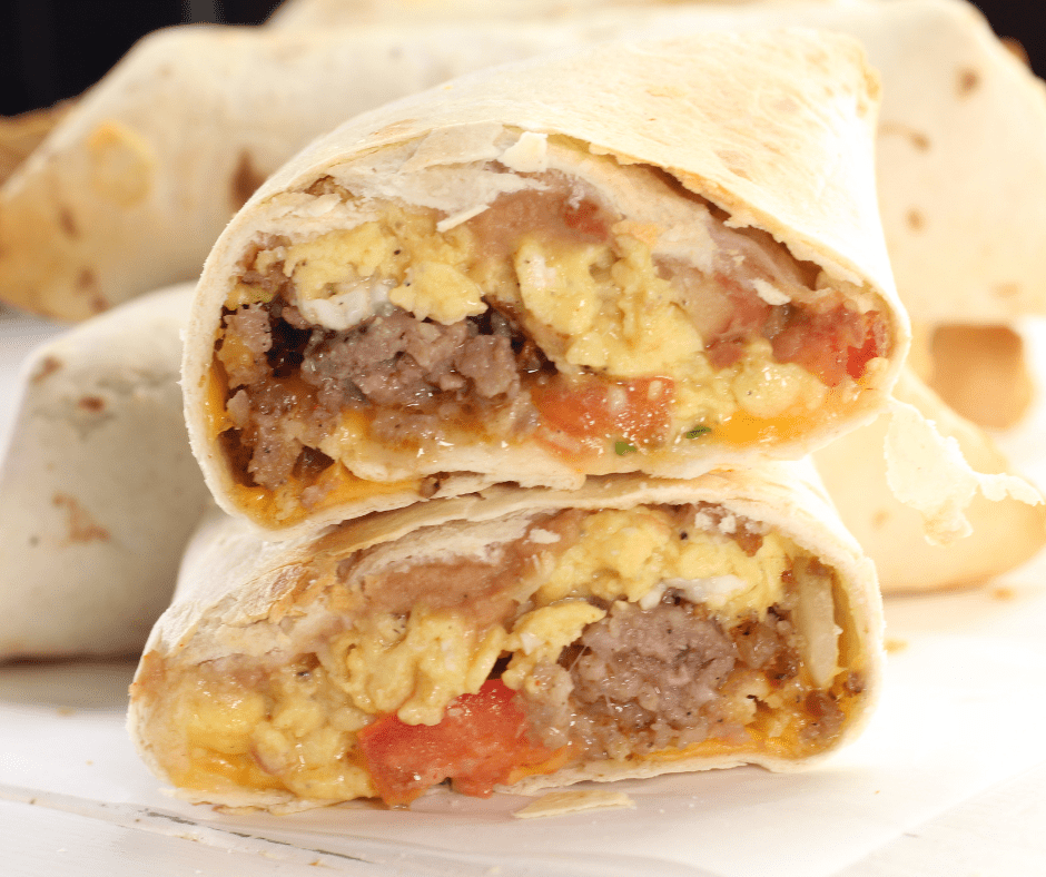 Golden and crispy Air Fryer Copycat McDonald's Breakfast Burritos, cut in half to reveal fluffy eggs, cheese, and sausage filling.