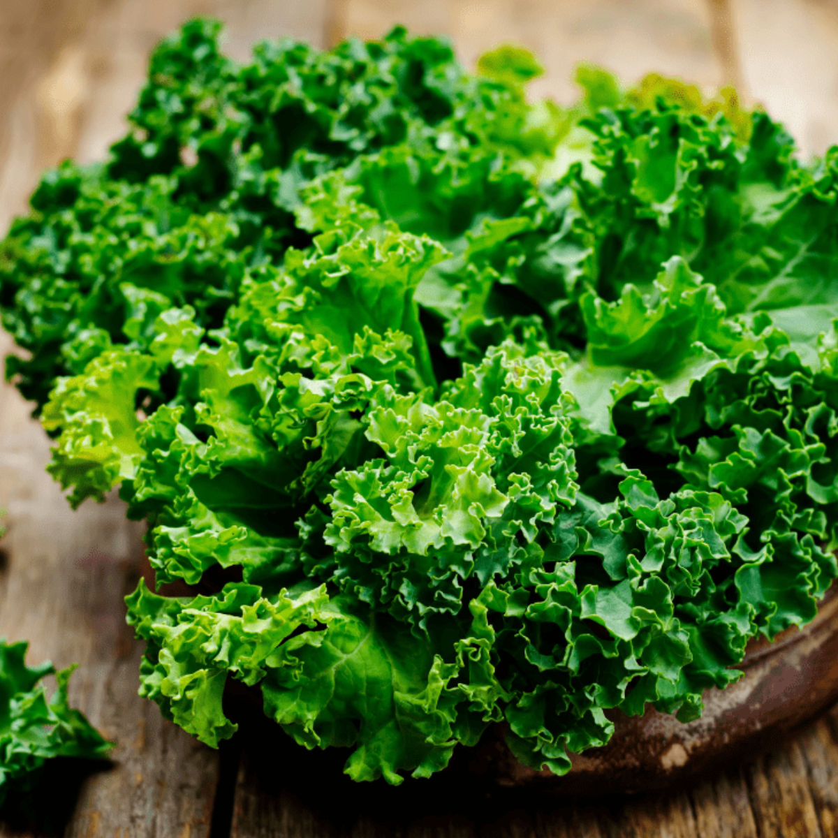 Fresh kale on cutting board.