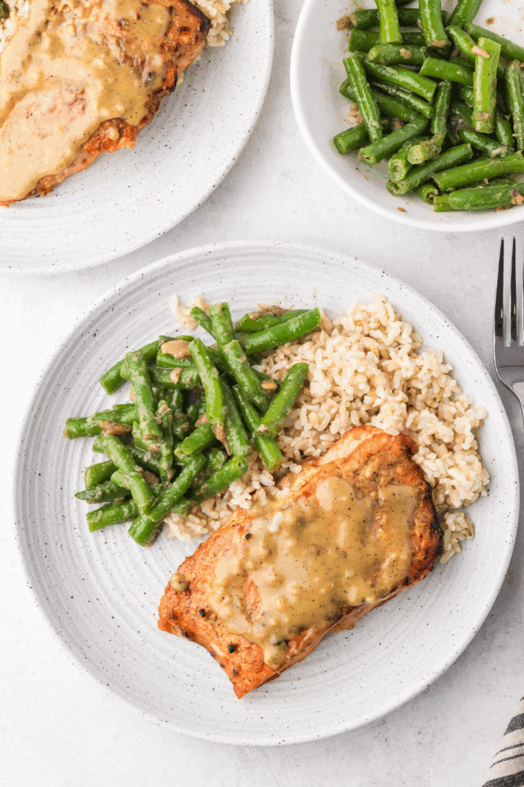 Homemade Cheesecake Factory miso salmon glazed with sweet miso sauce, served over rice with vegetables.