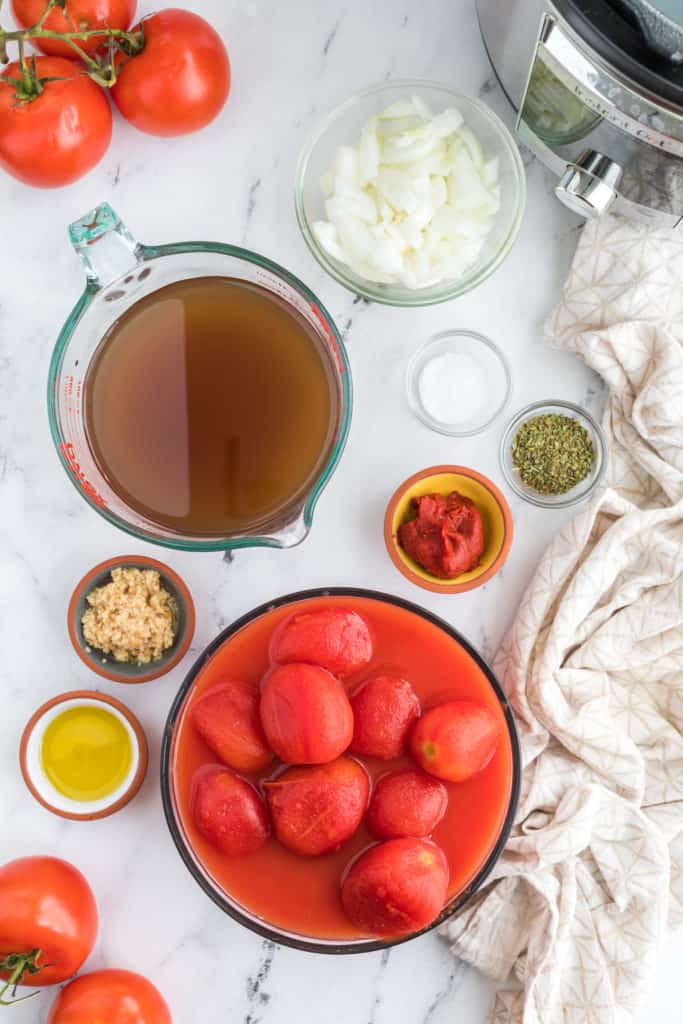 "Ingredients for Instant Pot Panera Creamy Tomato Soup laid out on the kitchen counter."
