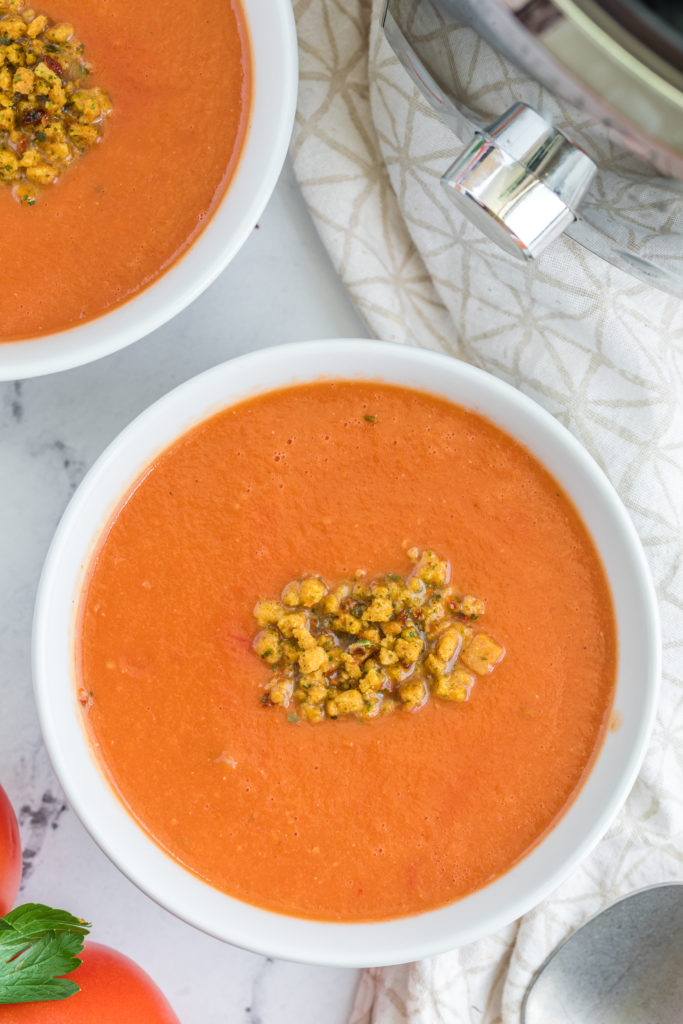 "Pouring the finished creamy tomato soup from the Instant Pot into serving bowls."