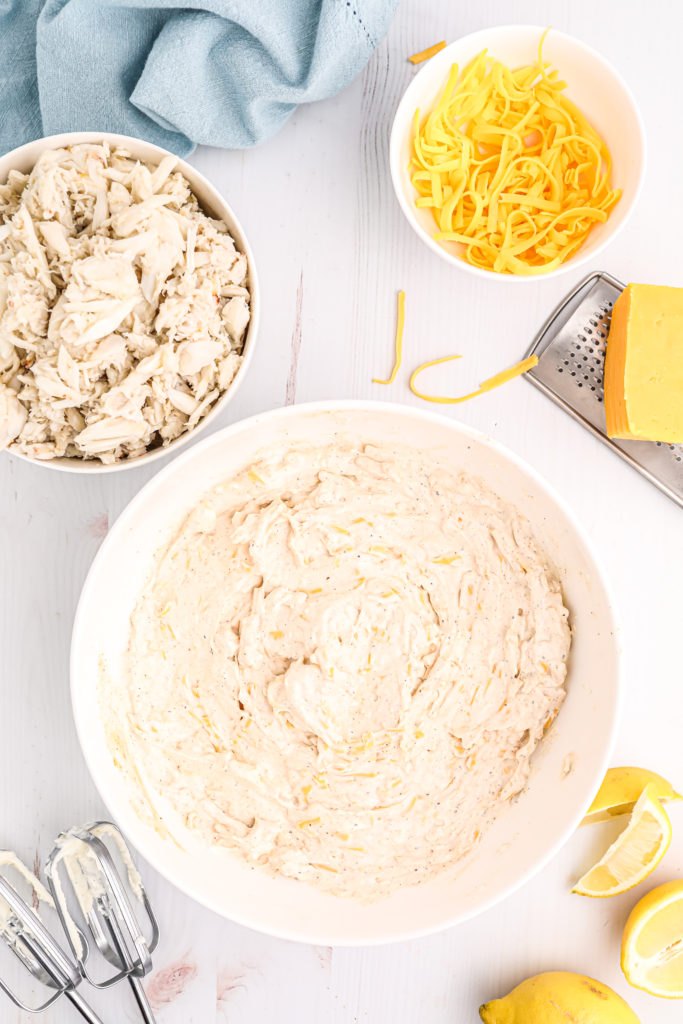 Mixing cream cheese, crab meat, garlic, and seasonings in a mixing bowl for Air Fryer Hot Crab Dip.