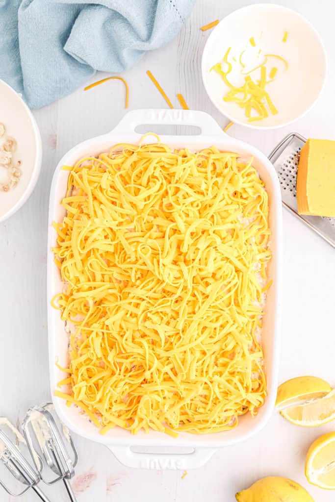 Placing the baking dish in the air fryer basket to cook the Hot Crab Dip