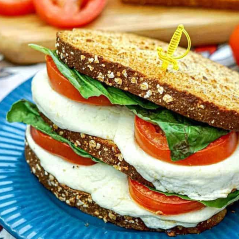 "Air Fryer Caprese Sandwich with melted mozzarella, fresh tomatoes, basil, and balsamic glaze on toasted bread."