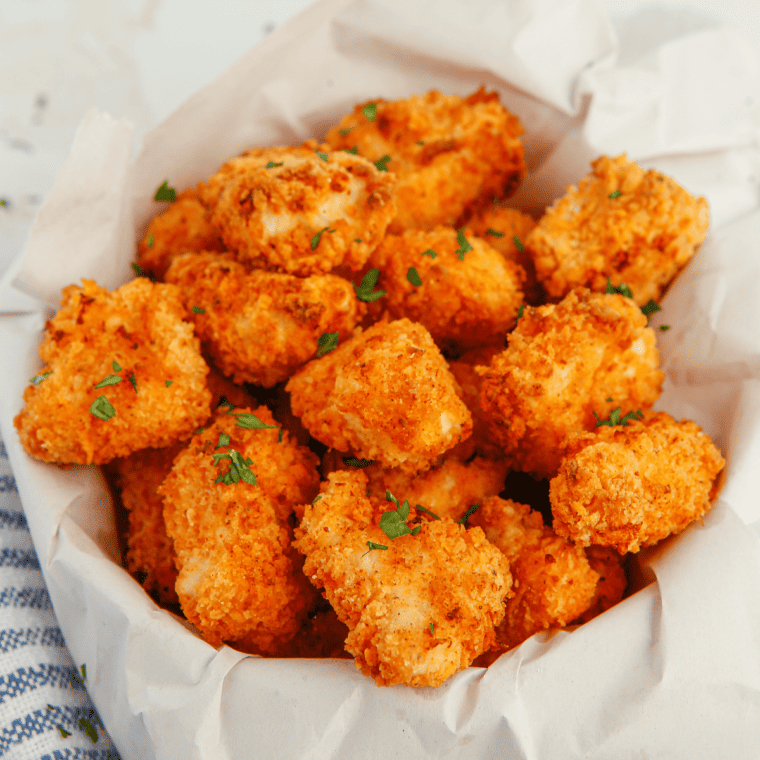 Close-up of air fryer popcorn chicken with crunchy breading and steam rising