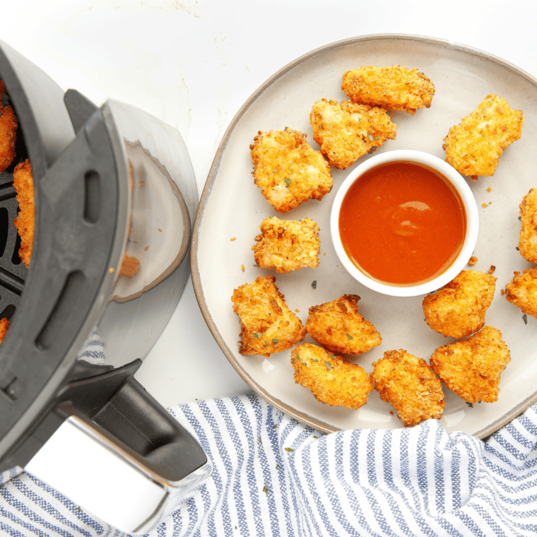 Close-up of golden popcorn chicken with crunchy textured coating fresh from air fryer