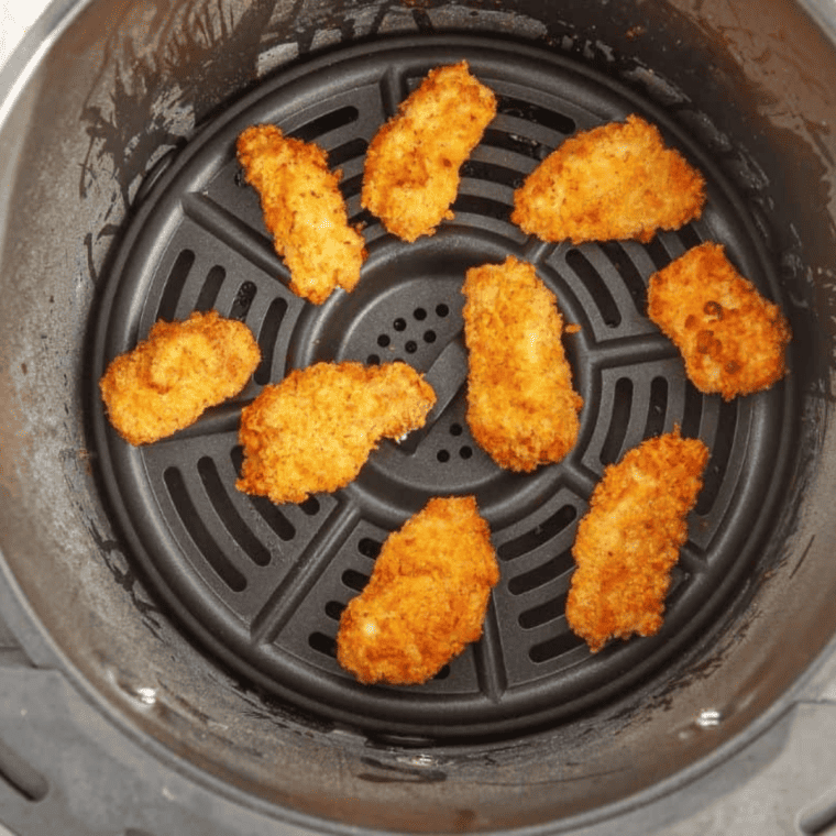 Freshly air fried popcorn chicken resting on a wire rack to stay crispy and drain excess heat without getting soggy