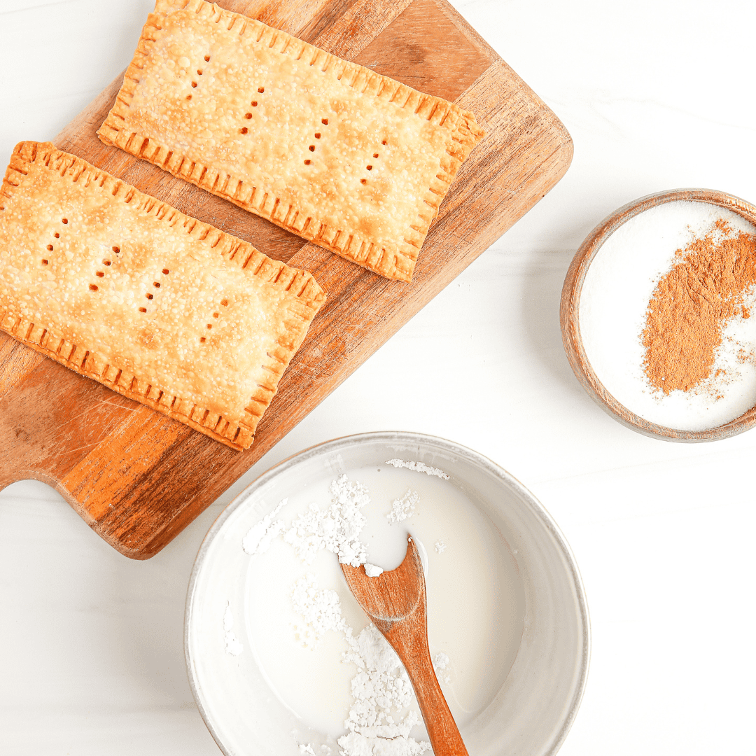 Air Fryer Pumpkin Pie Pop-Tarts on a plate with a drizzle of icing."