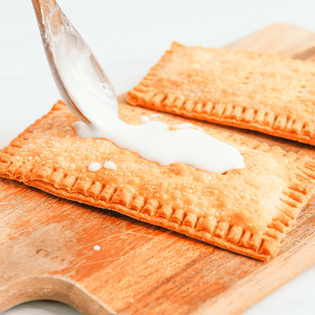 Air Fryer Pumpkin Pie Pop-Tarts with autumn leaves as a backdrop.