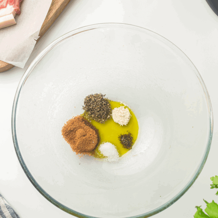 Ranch seasoning and olive oil combined in a bowl to coat the pork chops